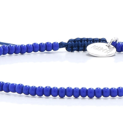 Detailed view of Stretch Bead Bracelets with blue seed beads with black cord, seed bead texture, and cord knot