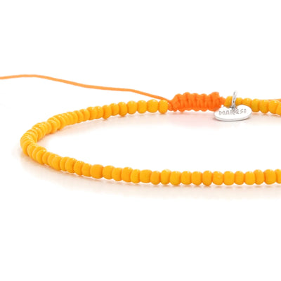 Close-up of Top Men Bead Bracelet Styles showing orange seed beads with matching cord, silver charm, and cord closure