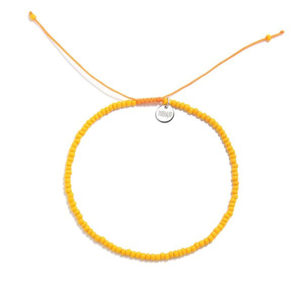 Top Men Bead Bracelet Styles shown from above with orange seed beads with matching cord and round bracelet shape