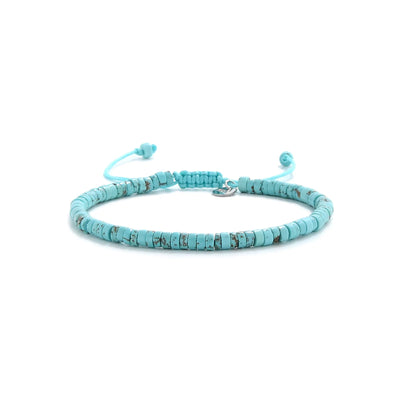 turquoise beads shown in full view with turquoise clay beads with silver charm and adjustable cord