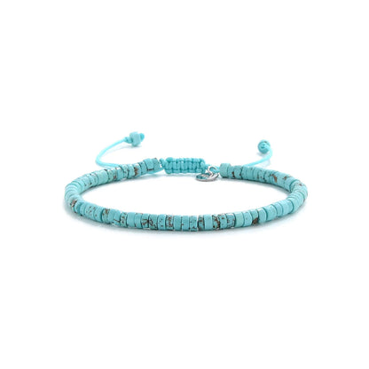 turquoise beads shown in full view with turquoise clay beads with silver charm and adjustable cord