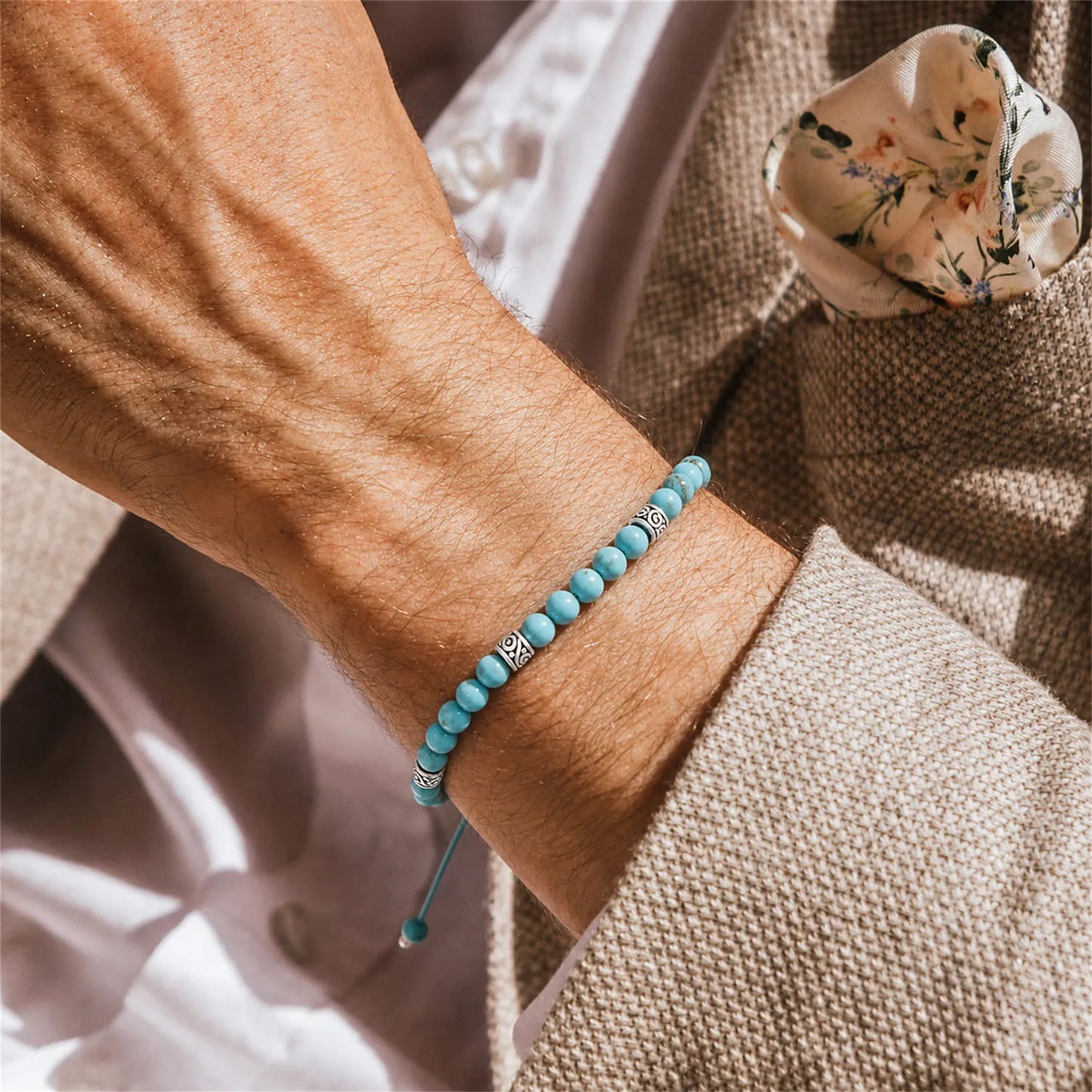 Turquoise Bracelet worn on a wrist with beaded design and adjustable cord