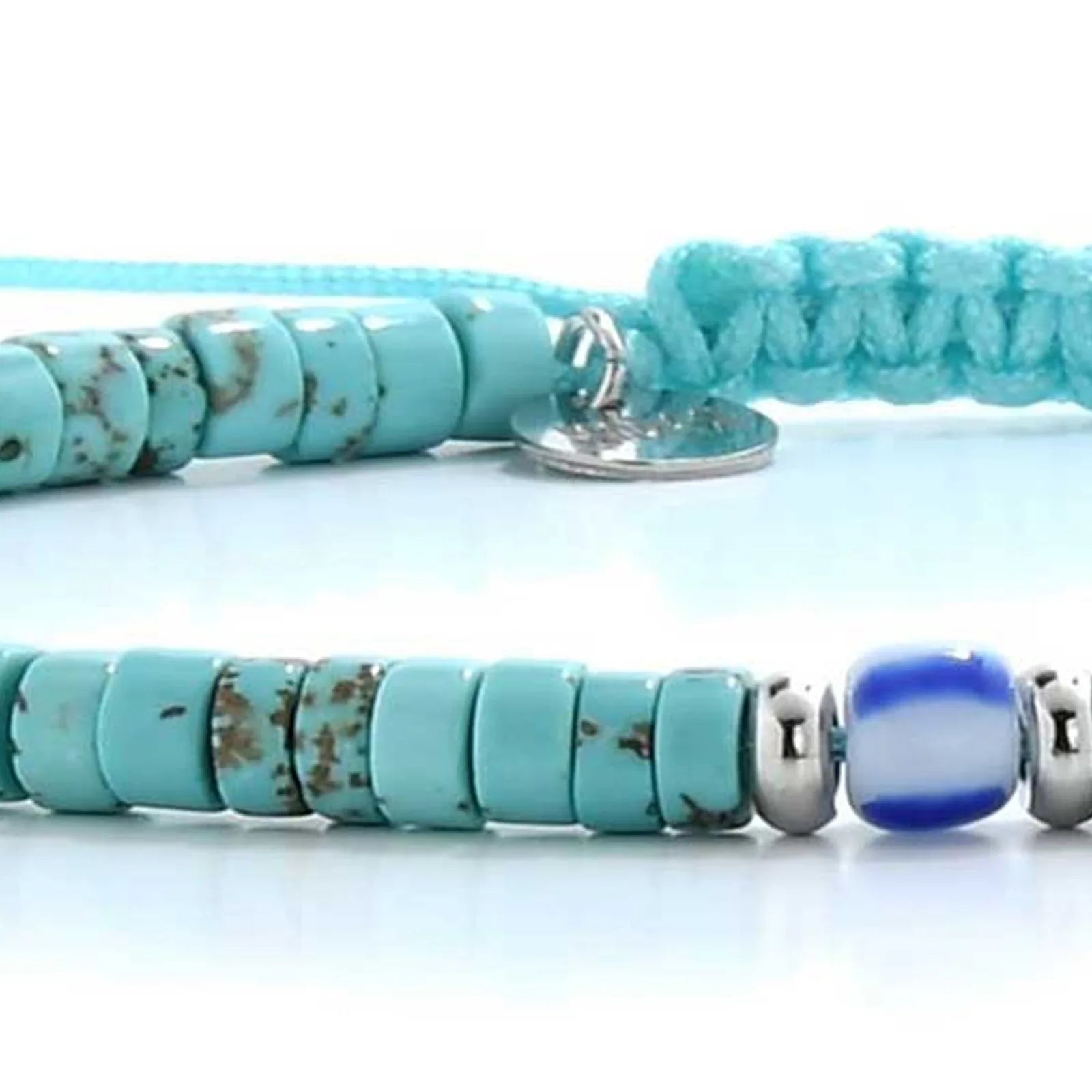 Detailed view of turquoise men's bracelets with turquoise clay beads with blue accent bead, Santorini clay bead texture, and