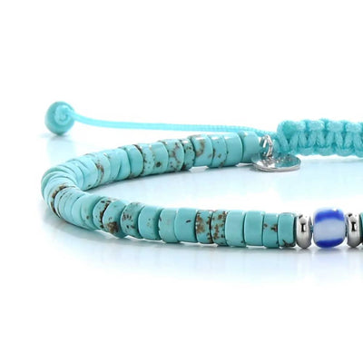 Close-up of turquoise men's bracelets showing turquoise clay beads with blue accent bead, silver charm, and cord closure