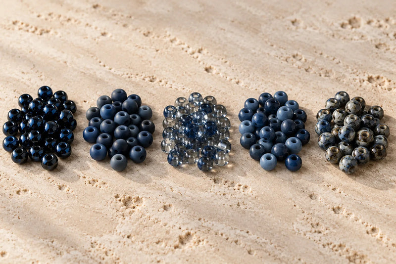 Types of Seed Beads with glossy, matte, transparent, opaque, and mottled finishes arranged in five groups.