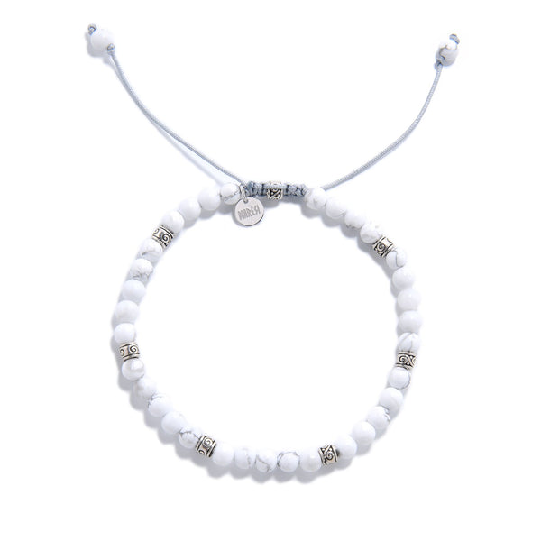 White Howlite Bracelet top view with round beads, charm, and adjustable cord