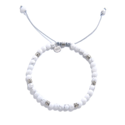 White Howlite Bracelet top view with round beads, charm, and adjustable cord