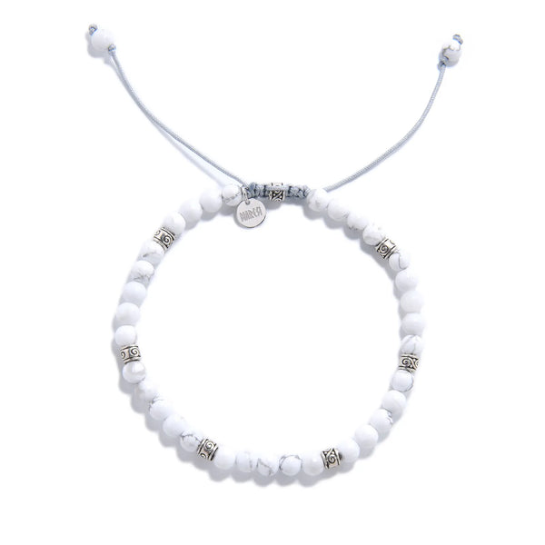 White Howlite Bracelet top view with round beads, charm, and adjustable cord