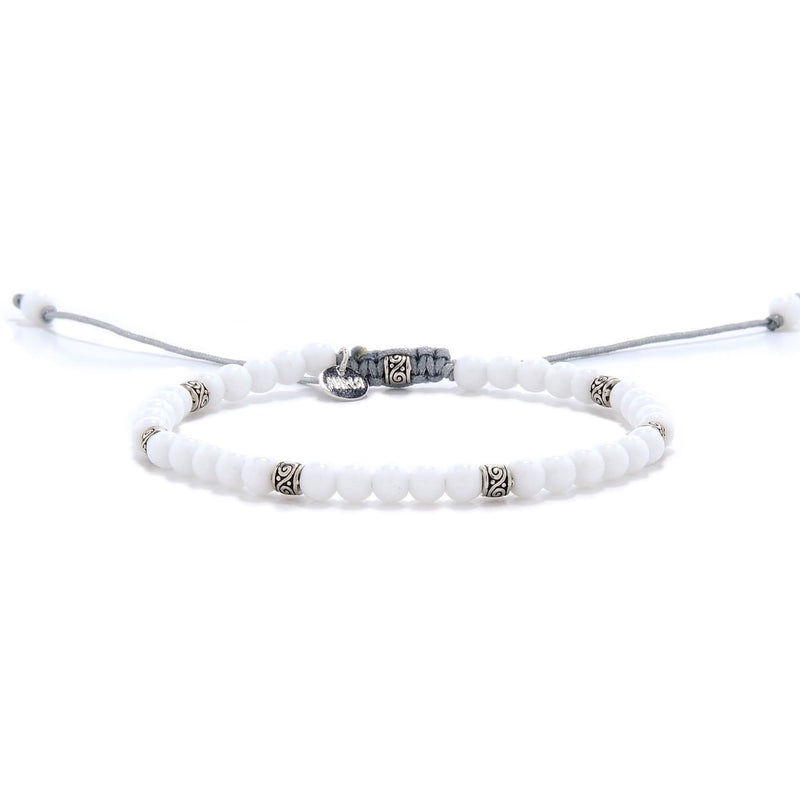 White Jade Bracelet full view with white round beads, silver spacers, and light gray adjustable cord.
