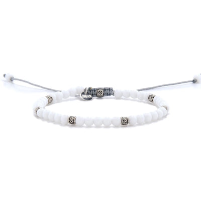 White Jade Bracelet full view with white round beads, silver spacers, and light gray adjustable cord.
