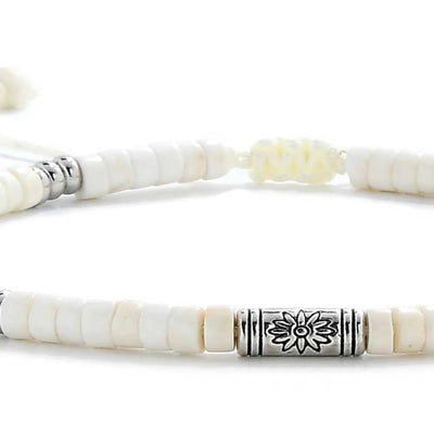 Detailed view of White Stone Jewelry with white clay beads with engraved silver spacers, Shamballa clay bead texture, and