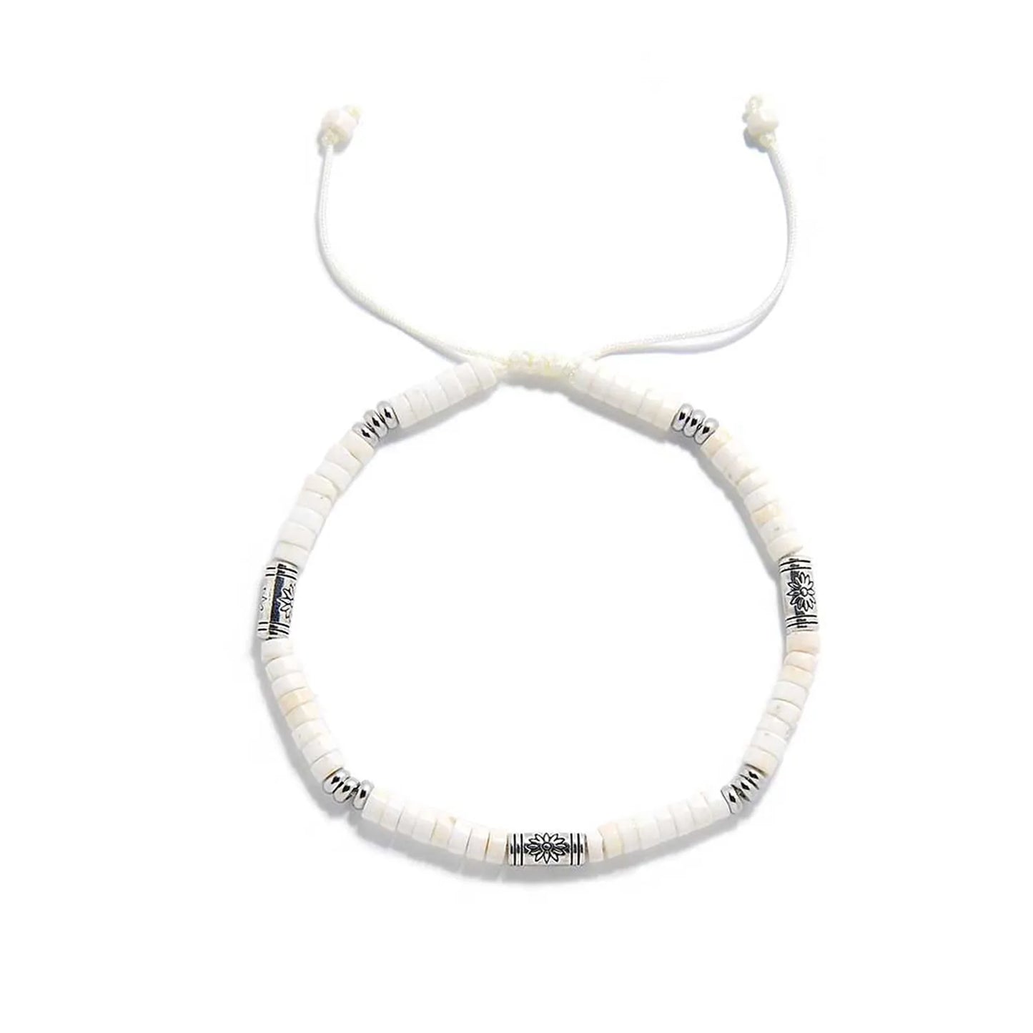 White Stone Jewelry shown from above with white clay beads with engraved silver spacers and round bracelet shape