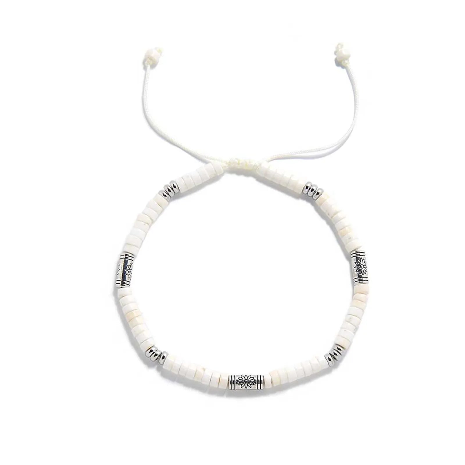 White Stone Jewelry shown from above with white clay beads with engraved silver spacers and round bracelet shape