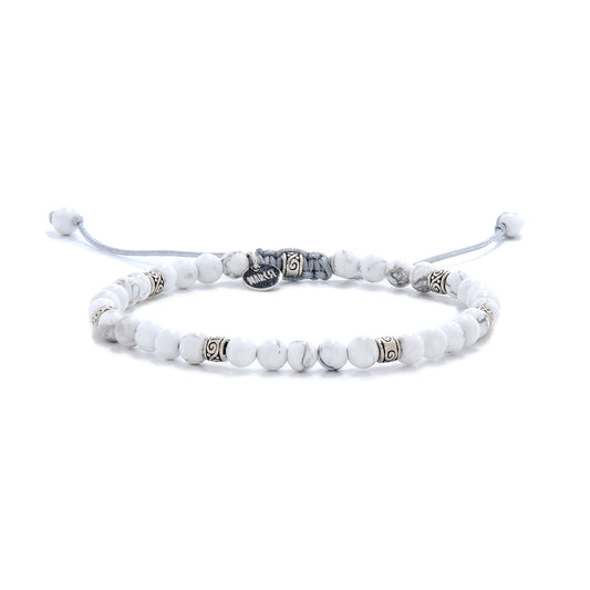 White howlite bead bracelet displayed on a white background, featuring silver accents and a braided adjustable cord.