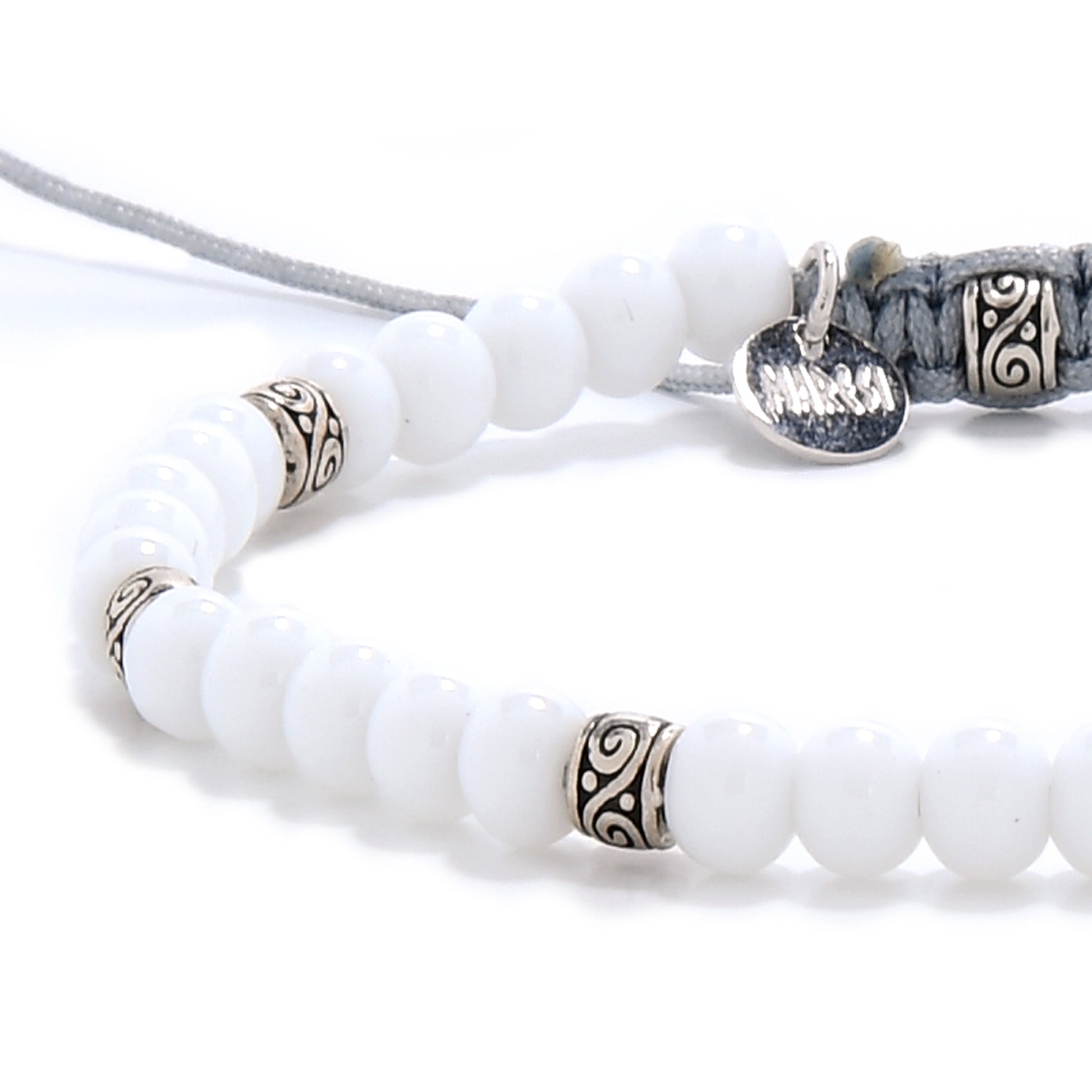 Detailed view of white jade bracelet’s beads and silver spacer design, highlighting craftsmanship.