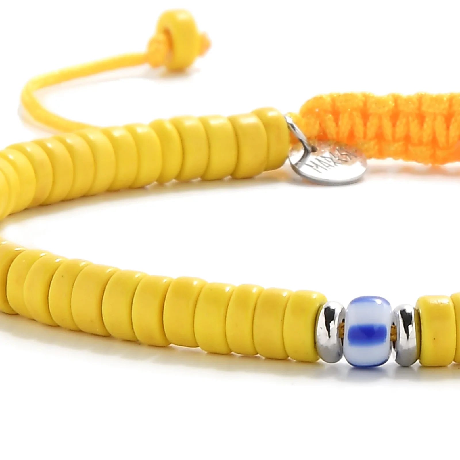 Detailed view of Yellow Beads with yellow clay beads with blue accent bead, Santorini clay bead texture, and cord knot