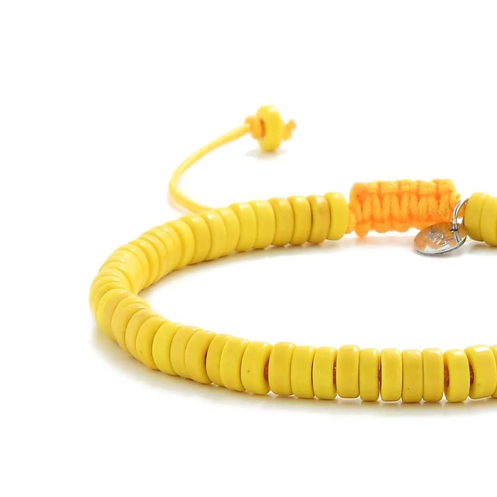 Close-up of Yellow Bracelet showing yellow clay beads with silver charm, silver charm, and cord closure