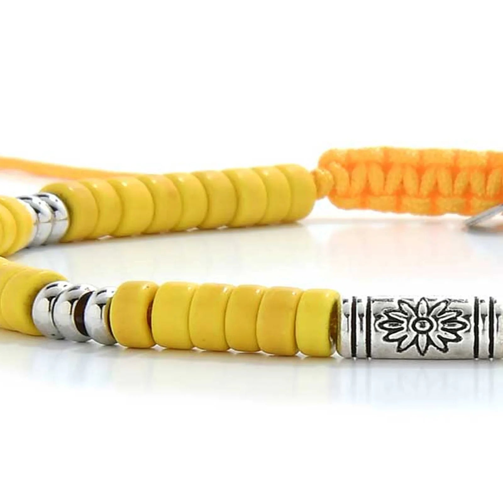 Detailed view of Yellow Gemstone Jewelry with yellow clay beads with engraved silver spacers, Shamballa clay bead texture,