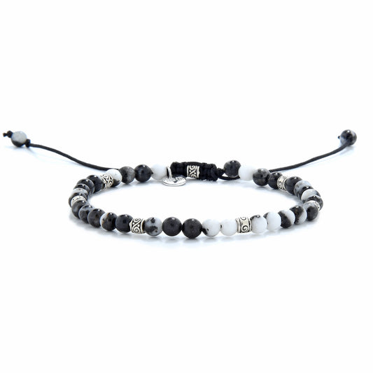 Zebra jasper bracelet with silver spacer beads on adjustable black cord, showcasing the natural contrast of black and white stones